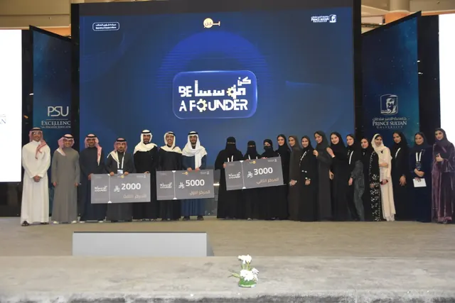 Between team and winners on stage at Prince Sultan University